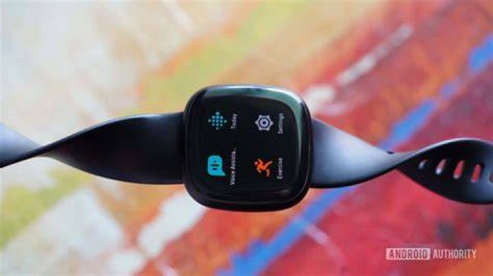 Fitbit Versa 3 Abstract A Fitbit Versa 3 rests on an abstract, colorful background.