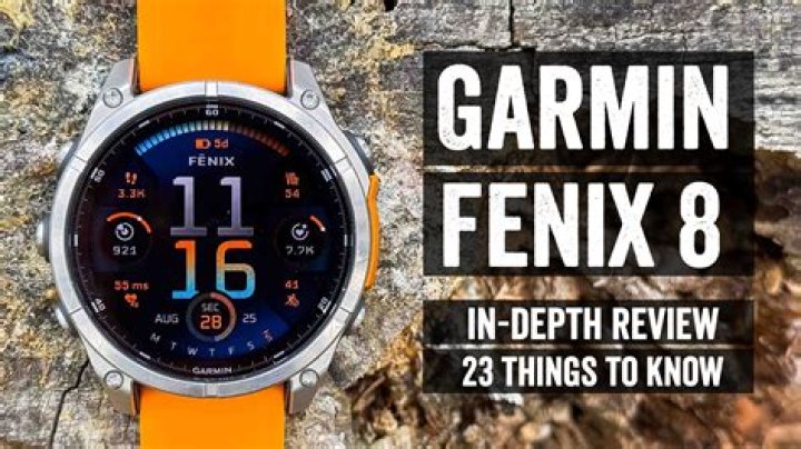 A Garmin Fenix 7 rests on a wooden post displaying topoactive map nearby locations.