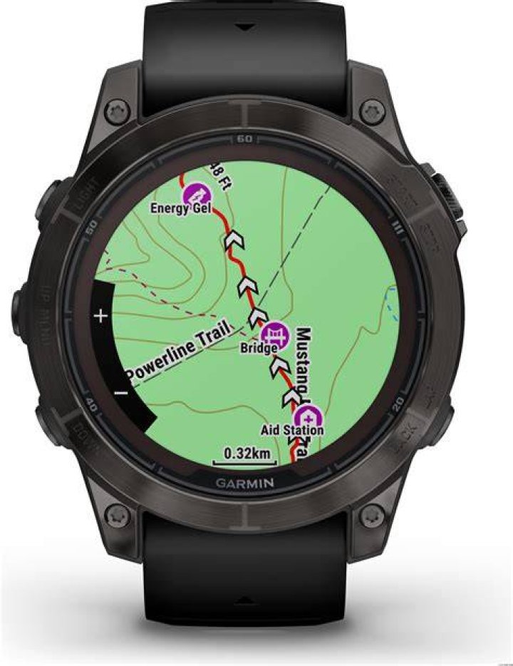 A Garmin Fenix 7 Sapphire Solar displays a clock face on a users wrist.