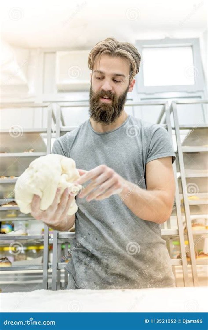 A man preparing dough in a kitchen A man preparing dough in a kitchen