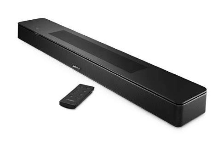 Bose_Soundbar_700 Bose smart speaker soundbars: Product image of the Bose Souundbar 700 (white) from Bose press release. The soundbar sits ona wood TV stand with a TV above it.