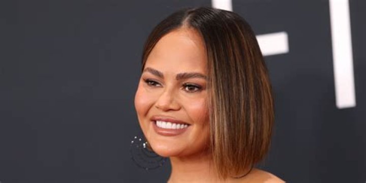 Chrissy Teigen flashes ample assets and lacy bra in unbuttoned semisheer dress Celebrity News