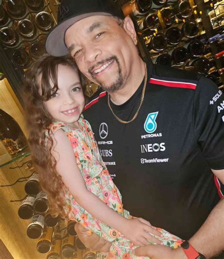 Coco Austin sits on Ice-T's lap in white outfit