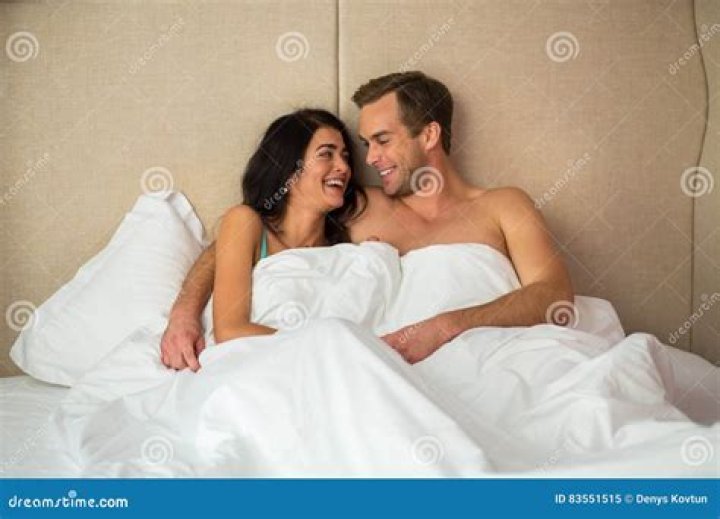 Couple laughing in bed