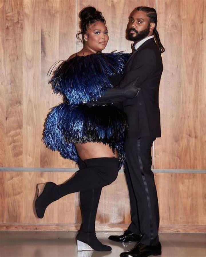 Drake and Lizzo posing on red carpets