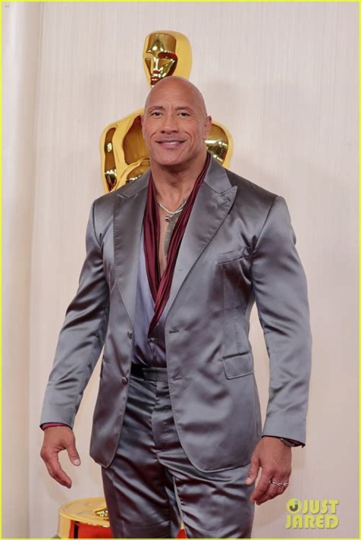 Dwayne Johnson smiling on a red carpet