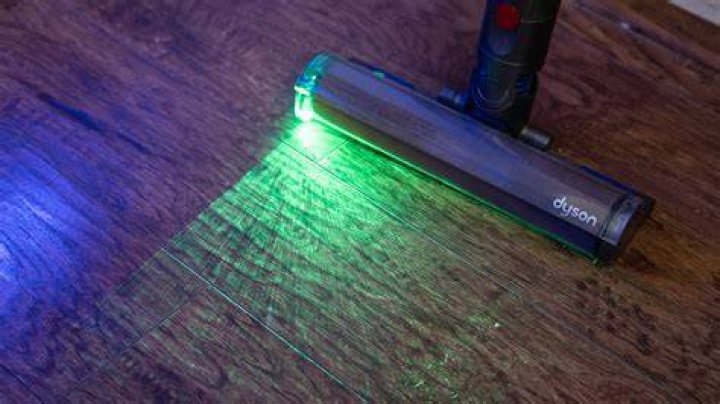 Dyson V15 Detect showing front with laser on Dyson V15 Detect showing front with laser on