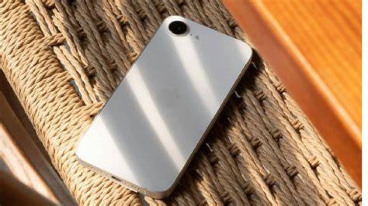iphone se on chair iPhone SE propped on chair showing screen