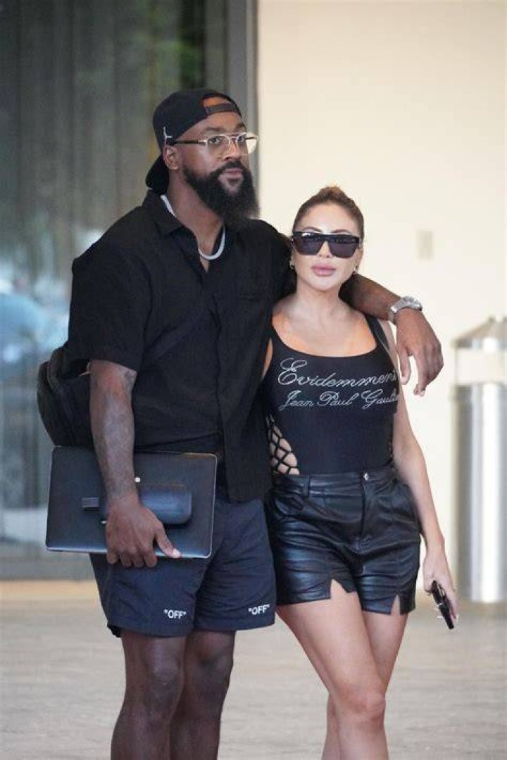 Larsa Pippen and Marcus Jordan posing for photo on a golf course