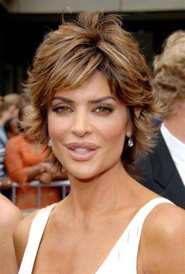Lisa Rinna posing for a photo on a red carpet.
