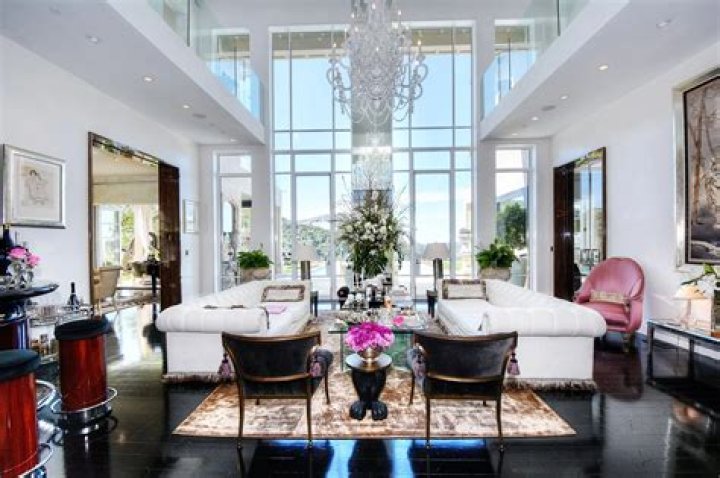 lisa vanderpump villa rose house entryway with two dogs sitting there and pink shed with two ponies