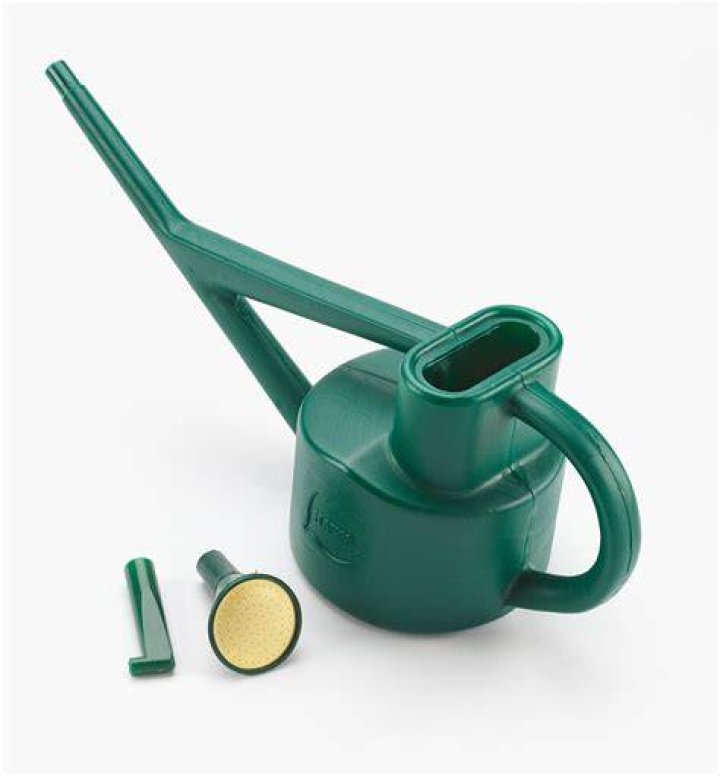 Minit watering can next to base