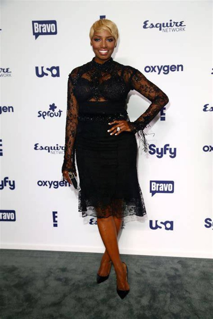 Nene Leakes wearing a black gown with her hands on her waist