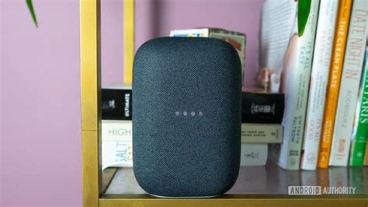Google Nest Audio from the front The gray Google Nest Audio speaker pictured on a white desk in front of computer screens.
