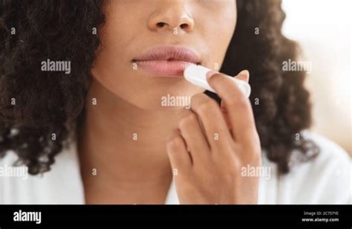 Woman applying chapstick